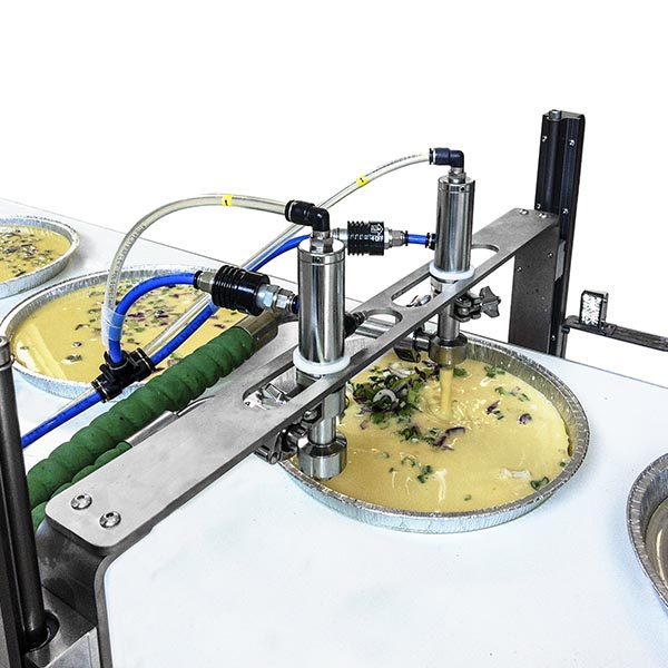 Dosing system with two-way valve on belt for the dosing of chickpea cake